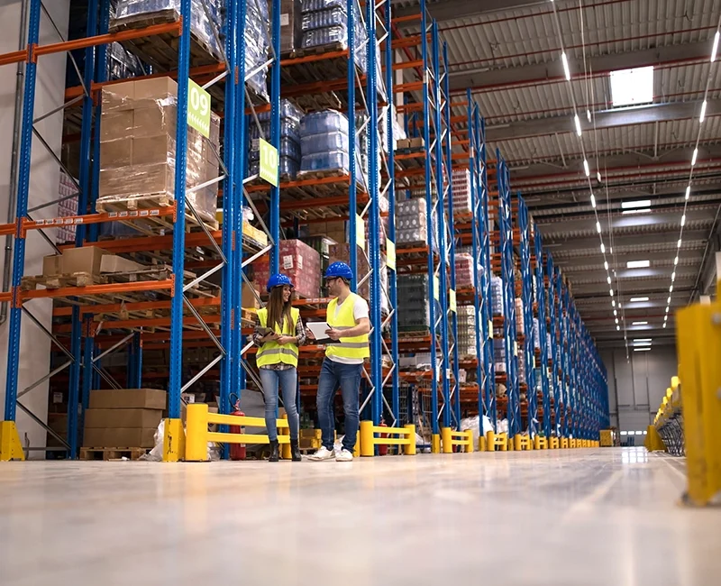 warehouse-workers-discussing-about-logistics-distribution-packages-market.webp