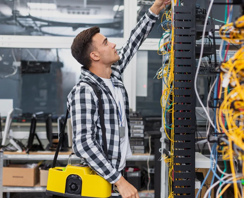 young-network-engineer-with-box-looking-ethernet-switches.webp